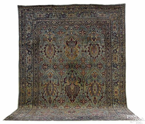 Kirman carpet, ca. 1920, with a large medallion on a blue field, 17'10'' x 11'6''.