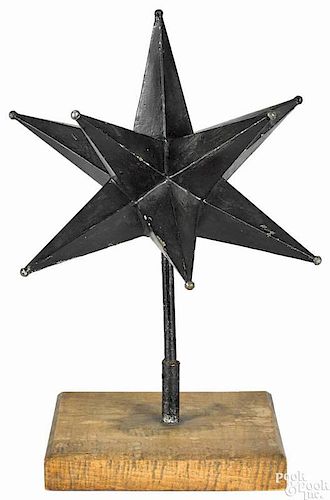 Painted tin Moravian star, 19th c., retaining an old black surface, with a stand, 20 1/2'' h.