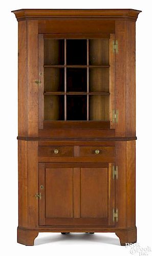 Pennsylvania cherry two-part corner cupboard, ca. 1825, 87 1/2'' h., 44 1/4'' w.