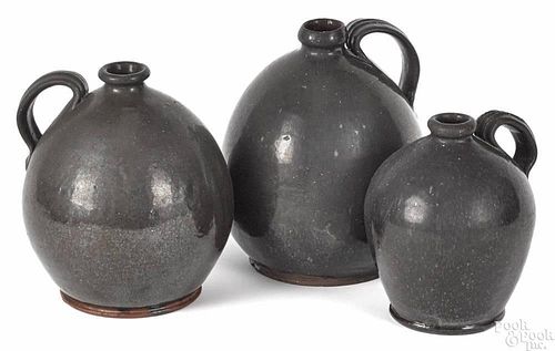 Graduated set of three redware ovoid jugs, 19th c., 8 1/2'' h., 8'' h., and 7'' h.
