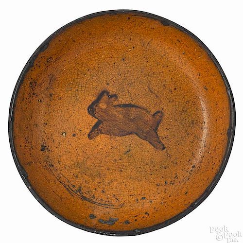 Pennsylvania redware plate, 19th c., with a slip decorated running rabbit, 7 1/2'' dia.