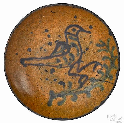 Pennsylvania redware bird plate, early 19th c., having a brown slip decorated bird