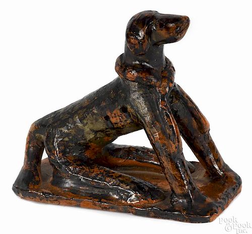 Pennsylvania molded redware seated dog, 19th c., with oversized rear legs on a slab base