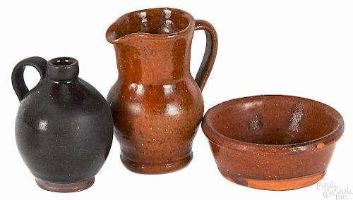 Three miniature pieces of redware, 19th c., to include a pitcher, 3'' h., an ovoid jug, 2 1/2'' h.