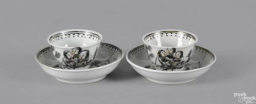 Pair of miniature Chinese export tea cups and saucers, 19th c., decorated with a mother and childr