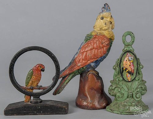 Three painted cast iron parrot figural doorstops, early 20th c., tallest - 12 1/4''.