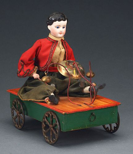 Seated Child on Wheeled Platform Bell Toy.