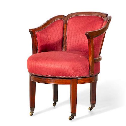 Neoclassical mahogany revolving library armchair