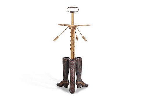 A whimsical addorsed boot form umbrella stand