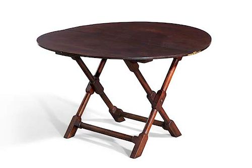 A George III walnut circular coaching table