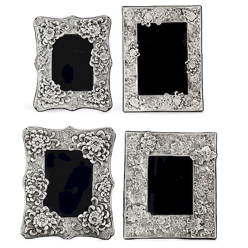 Four silver floral decorated  picture frames