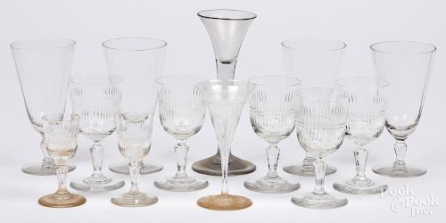 Group of colorless glass drinking vessels.