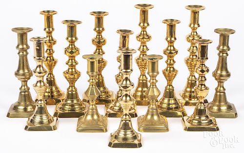 Seven pairs of English Victorian brass candlesticks