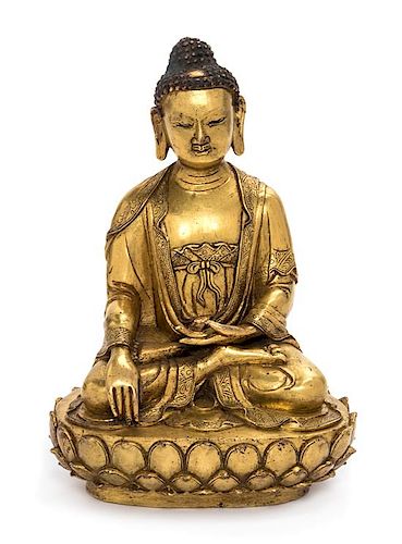 A Sino-Tibetan Gilt Bronze Figure of Shakyamuni Buddha Height 6 1/2 inches.