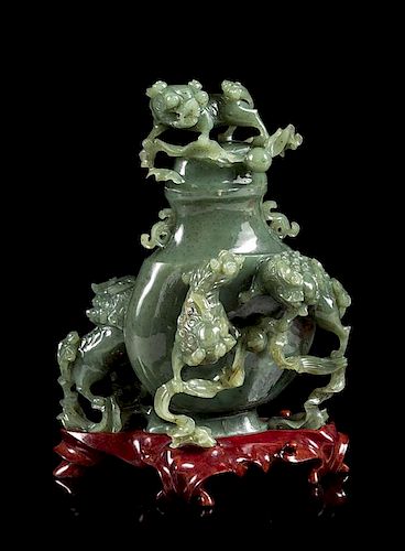 * A Spinach Jade 'Fu Lion' Vase and Cover Height 8 inches.
