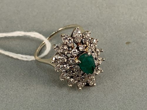14k white gold cocktail ring set with center emerald surrounded by thirty-nine diamonds. size 6 1/4