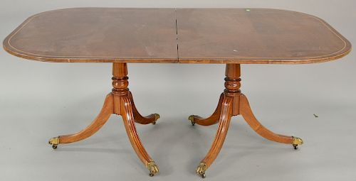 Mahogany double pedestal dining table with two 24'' leaves.. ht. 28 1/2 in., top: 44" x 68"