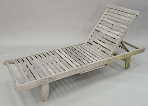Two outdoor teak pieces, lounge with pull out slides lg. 76 in. along with a coffee table ht. 17 1/2 in., top: 25" x 48".
