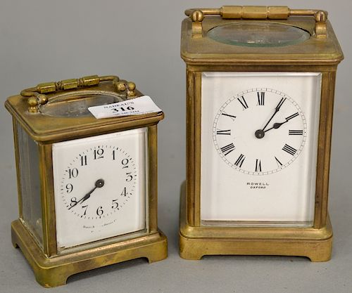 Two carriage clocks, Rowell oxford and Bailey Banks & Biddle, both brass and glass with white enameled face. ht. 4 in., & 5 1/2 in.
