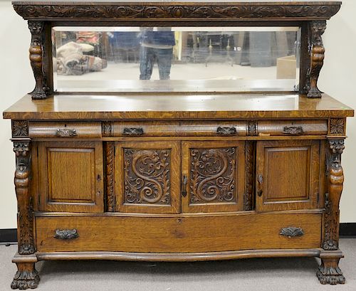 Carved oak two part sideboard with winged gargoyles and paw feet. ht. 60 in., wd. 72 in., dp. 28 in.