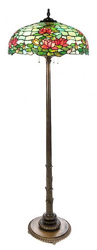A Duffner & Kimberly Leaded Glass and Bronze Water Lily Floor Lamp Height 72 1/2 x diameter of shade 24 inches.