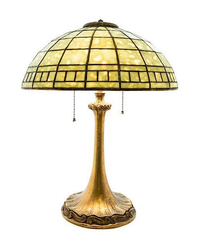 A Tiffany Studios Favrile Glass and Dore Bronze Geometric Table Lamp Diameter of shade 16 inches x height overall 20 3/4 inches.