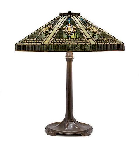 A Tiffany Studios Leaded Glass and Bronze Empire Jewel Table Lamp Height 26 x diameter of shade 22 inches.