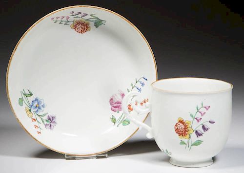 FRENCH CHANTILLY SOFT-PASTE PORCELAIN CUP AND SAUCER