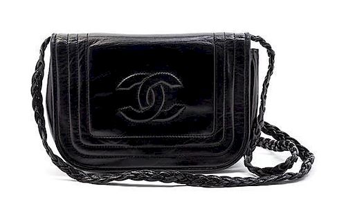 * A Chanel Black Leather Flap Bag, 7 x 4 1/2 x 1 1/2 inches.
