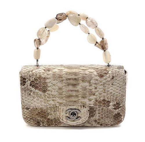 * A Rare Chanel Beige Python Mini Flap Bag, 7 x 4 x 1 1/2 inches.