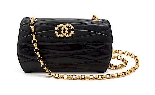 * A Chanel Black Quilted Leather and Faux Pearl Flap Bag, 7 1/2 x 4 1/2 x 2 1/2 inches.