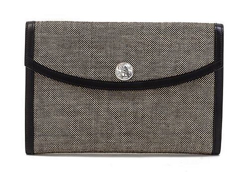 * An Hermes Black and Ivory Woven Toile Clutch, 9 1/2 x 6 1/2 x 1 inches.