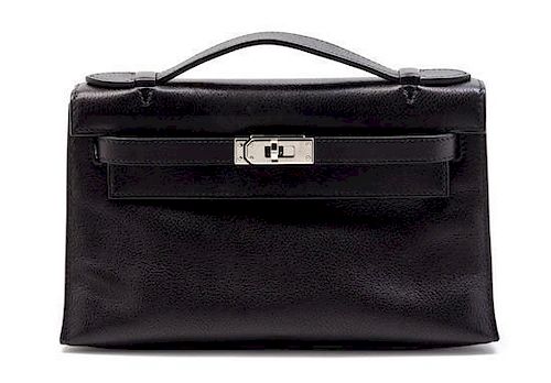 * An Hermes Black Leather Kelly Clutch Pochette, 8 1/2 x 5 x 2 1/2 inches.