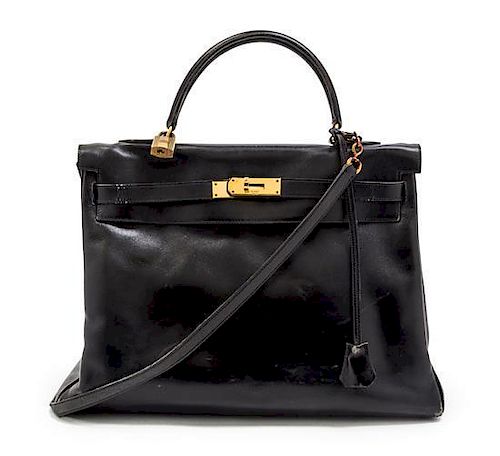 * An Hermes 35cm Black Leather Kelly Bag, 14 x 8 x 7 inches.