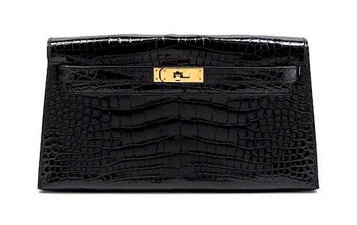 * An Hermes Black Shiny Alligator Kelly Clutch Bag, 11 x 6 x 1 1/2 inches.