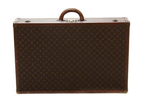 * A Louis Vuitton Monogram Canvas Hard-sided Suitcase, 31 1/2 x 20 x 6 1/2 inches.