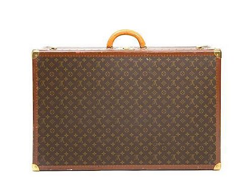 A Louis Vuitton Monogram Canvas Hard-sided Suitcase, 31 1/2 x 20 x 8 1/2 inches.