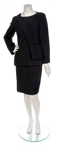 * A Chanel Black Wool Boucle Skirt Suit and Bag, Jacket size 40, skirt size 40.