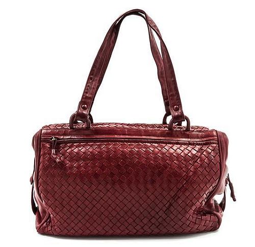 * A Bottega Veneta Burgundy Intrecciato Leather Duffle Bag, 14 x 8 x 6 inches.