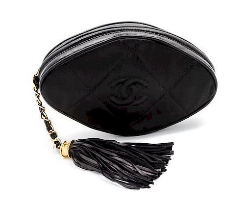 * A Chanel Black Satin Quilted Clutch, 7 1/2 x 4 x 2 inches.