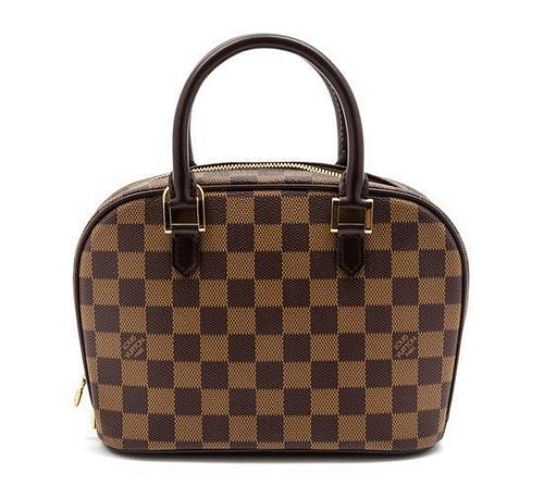* A Louis Vuitton Damier Canvas Sarria Bag, 8 1/2 x 6 1/2 x 3 1/2 inches.