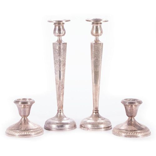 Four 20th century sterling candlesticks.