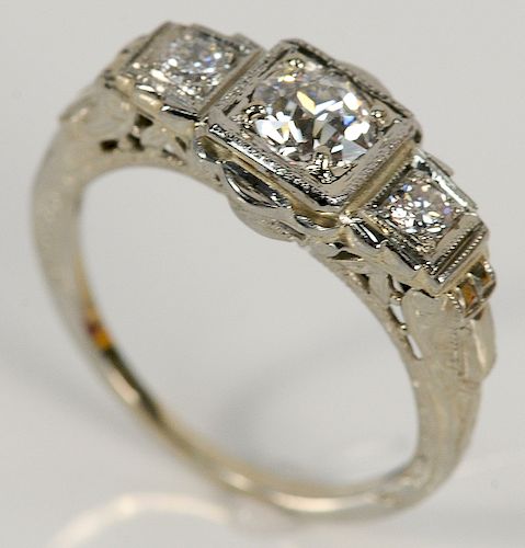 18 karat white gold ring set with center diamond approximately .50 cts, flanked by diamond on either side.  size 4 3/4