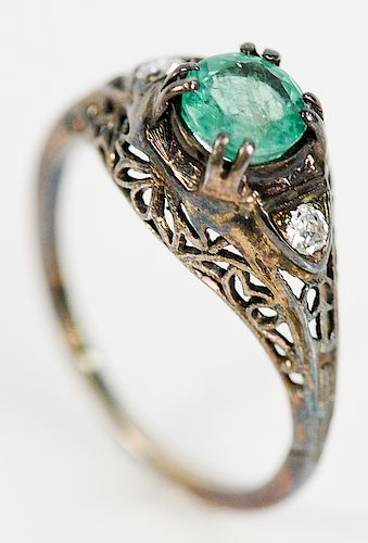 18 karat white gold filigree ring, set with round green stone and flanked by diamond on either side approximately .75 ct., probably...