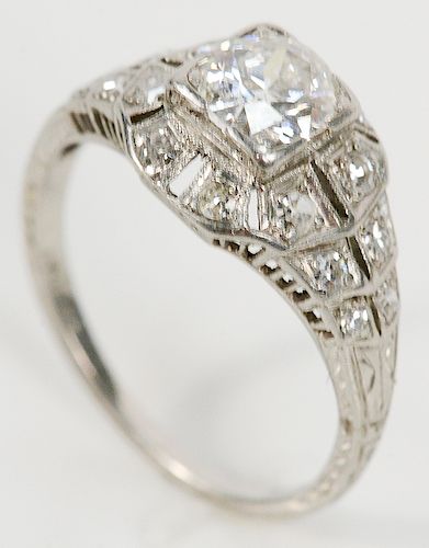 Platinum and diamond ring set with center diamond, approximately .75 cts., 5.8 x 5.8mm set with sixteen diamonds.  size 5 1/4