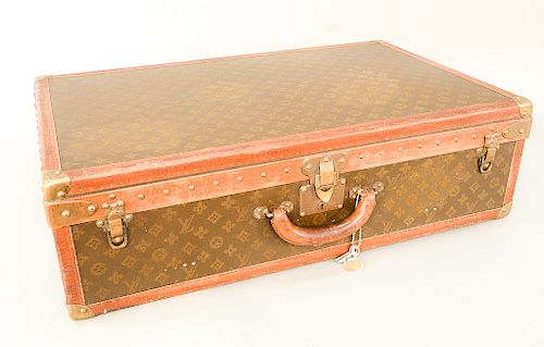 Louis Vuitton Paris, France suitcase, canvas hard sided, monogramed: LV with brass hardware and LV embossed leather trim, opening to...