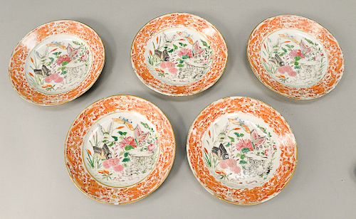 Group of five Famille Rose export plates, China, 18th century, painted with central design of butterflies and flowers, surrounded wi...