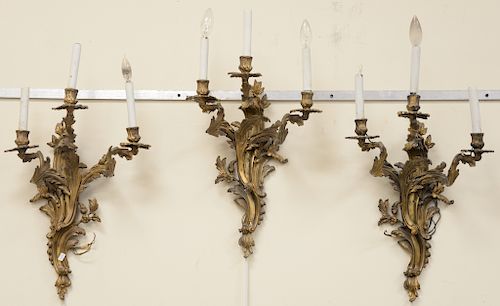 Set of eight French Rococo style bronze three light sconces.  ht. 24 in., wd. 14 in.  Provenance: From an estate in Lloyd Harbor...