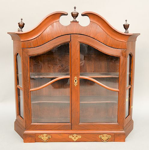 Mahogany hanging cupboard with broken arch top having two glazed doors and one drawer, 18th-19th century.  ht. 37 in., wd. 39 in.