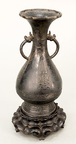 Bronze pear-shaped vase (Yuhuchunping), China, Yuan or Ming 14th-17th century, the body with raised archaic decoration, including in...